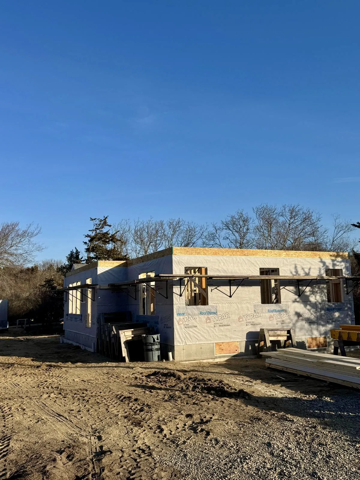 View of residential construction framing, focusing on wall and roof framework setup.
